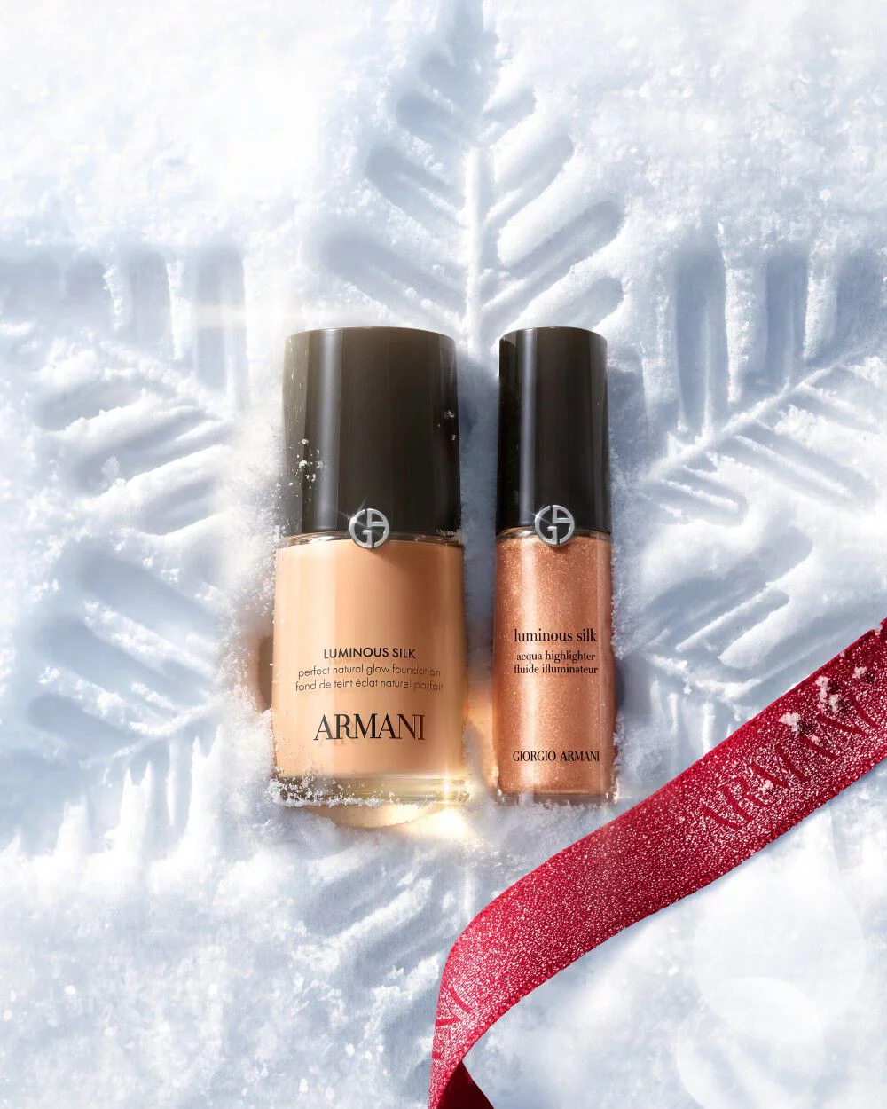 Armani beauty Luminous Silk foundation and concealer on snow with a red ribbon.