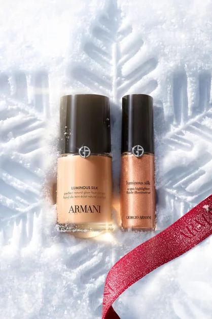Armani beauty Luminous Silk foundation and concealer on snow with a red ribbon.