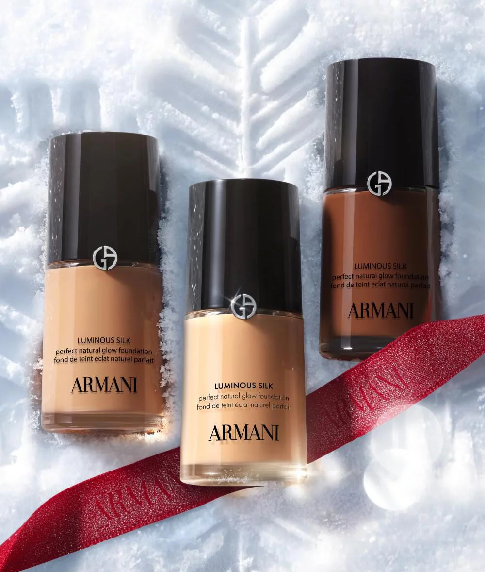 Armani beauty make-up products on snow for the Holiday 2026 winter glamour campaign.
