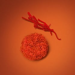 Fragrance notes of saffron and a textured spice accord for EMPORIO ARMANI STRONGER WITH YOU SPICES, showcased on an orange background to emphasize its vibrant, spicy signature.