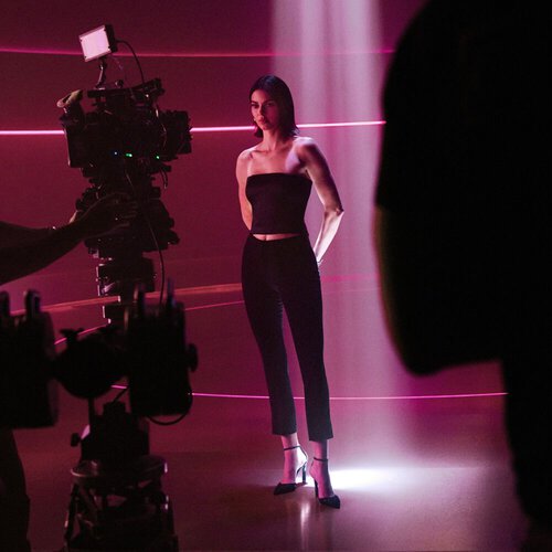 Kendall Jenner standing under a beam of ruby light on set, filmed in a captivating and inspiring moment for ARMANI POWER OF YOU.
