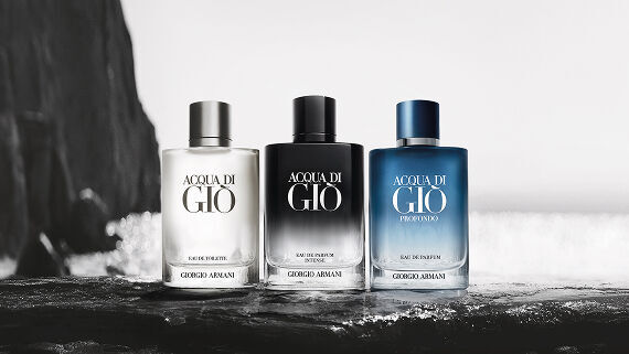 Three Armani fragrance bottles on a wet surface, emphasizing the brand’s elegant and aquatic identity.