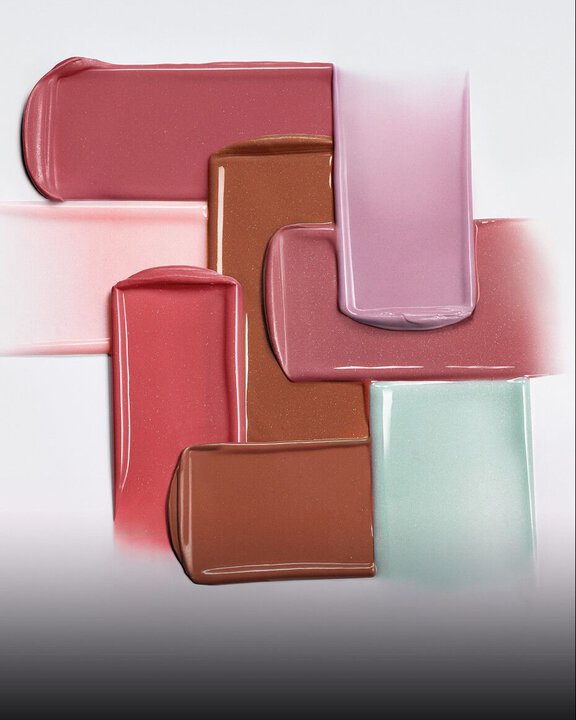 Armani Prisma Flash lipstick swatch in mauve, displayed with the iconic GA logo embossed in creamy, glossy color.