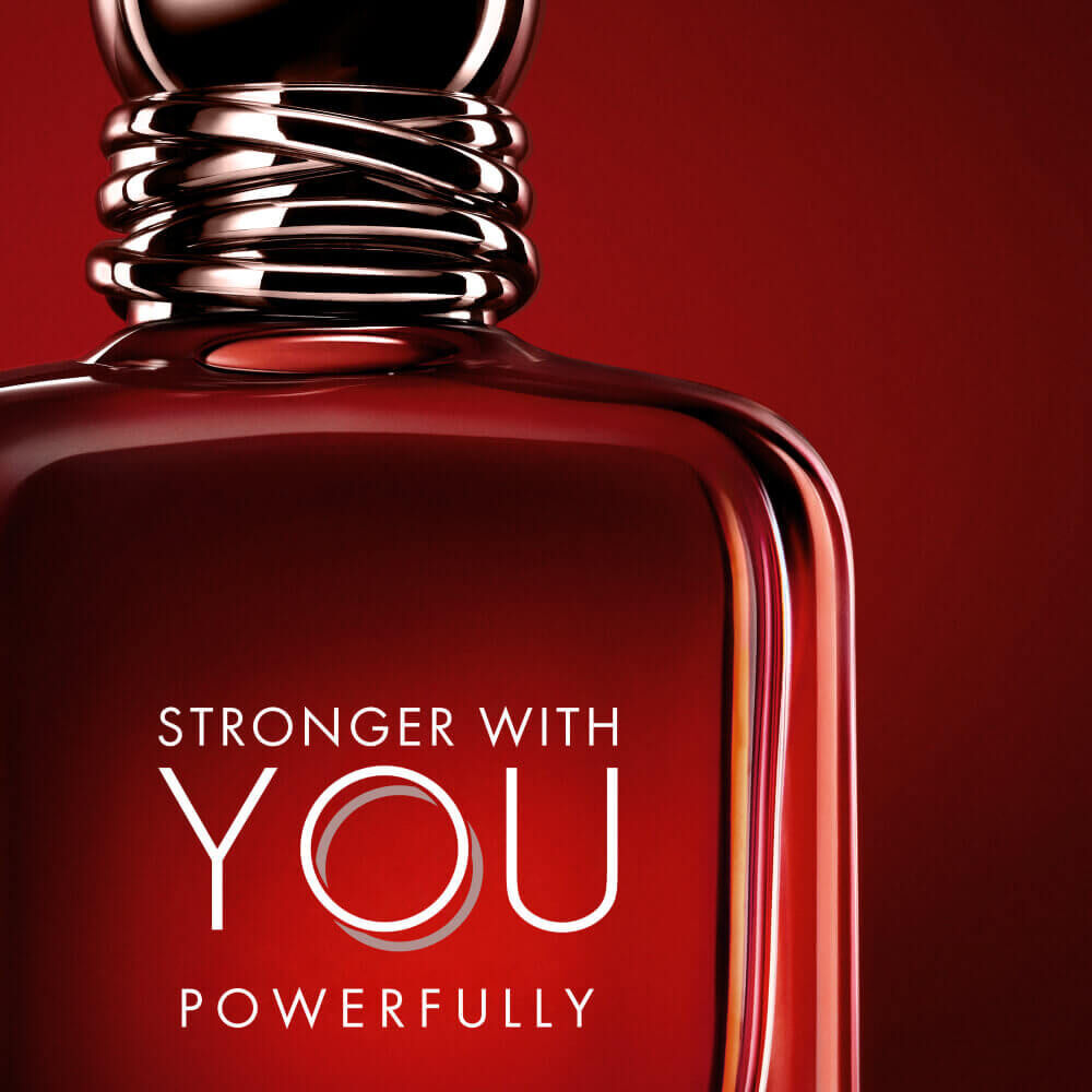 Emporio Armani Stronger With You Powerfully bottle on a bold red background.