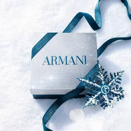 Emporio Armani Stronger With You Eau de Toilette 15ml, Stronger With You Intensely 15ml and Stronger With You Parfum 15ml — three-piece fragrance gift set with blue ribbon and snowflake ornament on a winter white surface.