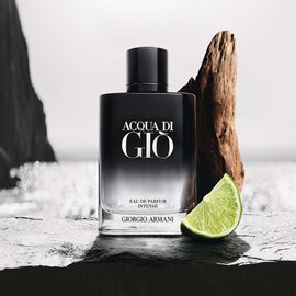 Giorgio Armani Acqua Di Gio Eau de Parfum Intense bottle by the sea with driftwood and lime.