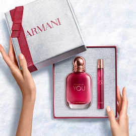 Hands unveiling a red-ribboned white Armani gift box with Power of You Eau de Parfum 50ml and 10ml — a bold, feminine fragrance gift set for women.