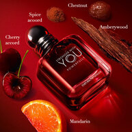 Armani Stronger With You bottle surrounded by cherries, orange, wood, and chestnuts.