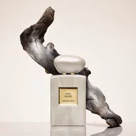 Armani Prive Oud Nacre perfume bottle with flowing Oud in the back