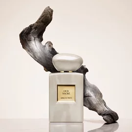 Armani Prive Oud Nacre perfume bottle with flowing Oud in the back