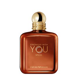 EMPORIO ARMANI STRONGER WITH YOU SPICES bottle displayed on a white background, featuring a warm amber hue and signature gold cap, reflecting Armani’s bold, modern fragrance.