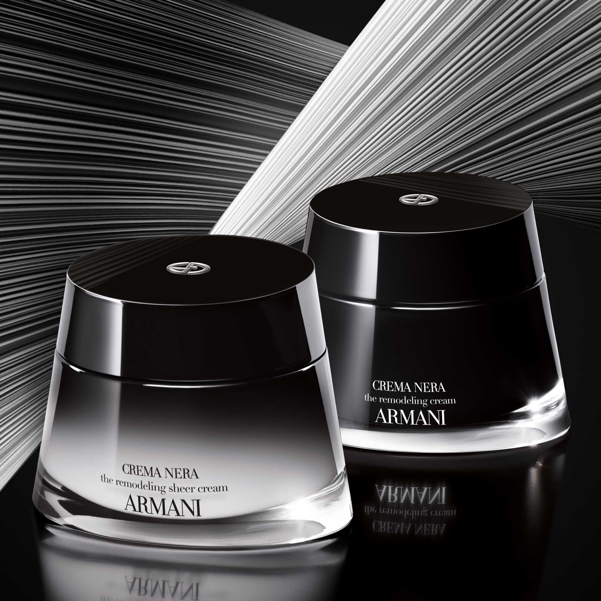 Two Giorgio Armani CREMA NERA Sheer Cream jars in black and white with radiating lines.